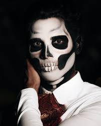 man in a skull makeup and costume for