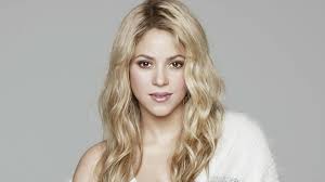 shakira poses in see through feathered