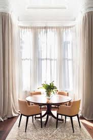 bay window with curtains or blinds