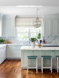 This custom kitchen by mustard architects was designed to show off the homeowner's eclectic dishware collection. Lanterns Over Light Blue Island Transitional Kitchen
