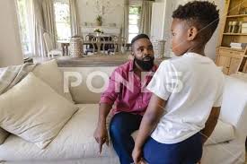 African American Father Sitting On Sofa