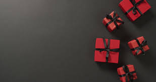 red gift bo with black ribbons on
