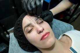 makeup artist plucks eyebrows in a