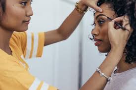 makeup artist preparing model for a