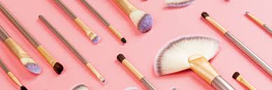 cosmetic makeup brushes on pink