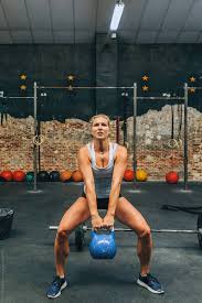 strong woman lifting heavy kettlebell