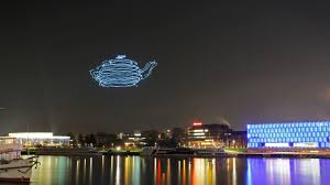 see drones draw shapes in the night sky