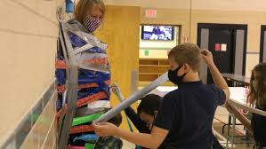 ICS students tape principal to wall after fundraiser