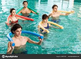 smiling young people exercising pool