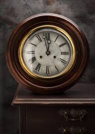 Antique Wall Clocks On A Vintage Table