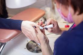 manicure master applying gel polish on