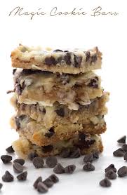low carb magic cookie bars in a stack with chocolate chips around them