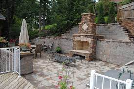 Stone Fireplace Built Into Retaining