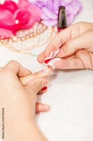 esthetician removes the old nail polish
