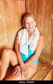 Old woman sits happily and relaxes in the sauna on wellness vacation Stock  Photo - Alamy