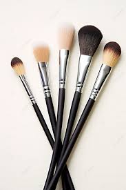 five diffe makeup brushes next to