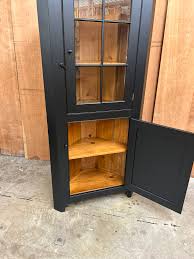 small gl door corner cabinet in
