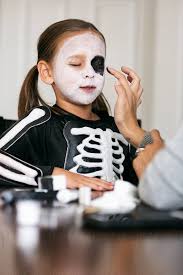 skeleton mother applying black makeup