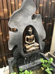 buddha in grotto water feature