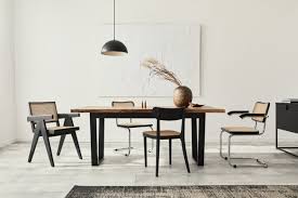 Wood flower design dining table design. Premium Photo Minimalist Composition Of Dining Room Interior With Wooden Table Design Chairs Dried Flowers In A Vase Black Pendant Lamp Art Paintings On The Wall And Elegant Personal Accessories