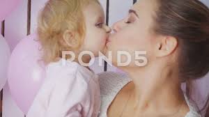 mother kiss her daughter sharing a