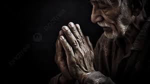 old man praying with his hands clasped