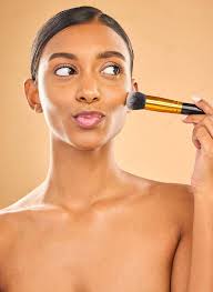indian woman applying makeup with happy