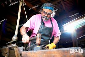 blacksmith working in his forge stock