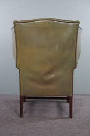 green leather winged armchair