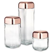 A Set Of Copper Top Glass Containers