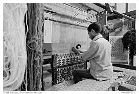 man weaving a carpet agra uttar