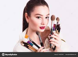makeup artist with brushes in hand on a