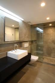75 concrete floor bathroom with a wall