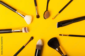 cosmetic makeup brush on yellow