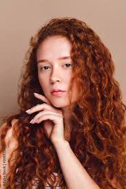 red haired model with long curly hair