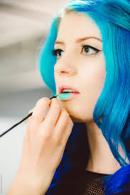 makeup artist applying blue lipstick