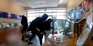 masked robbers smash display cases