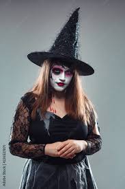 young woman in witch halloween costume