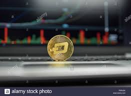 Golden Dash Coin On A Black Keyboard Of Silver Laptop And