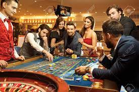 Happy People Gambling Poker Roulette In Casino. Stock Photo, Picture And  Royalty Free Image. Image 127792145.