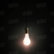 Light Bulb Hanging Against Grey Background Stock Photo Dissolve
