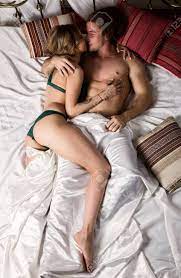 Young Sexy Couple In Erotic Pose On A Bed In Hotel Room. Romantic Newlyweds  In Intimate Environment Stock Photo, Picture and Royalty Free Image. Image  93555771.
