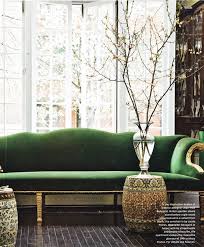 lush green velvet sofas in cozy living