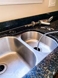 Removing an old faucet and putting in a new onethe tool to loosen those hard to reach faucet nuts is a basin wrench ; How To Remove And Replace Your Kitchen Faucet Simply2moms