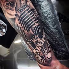 Maybe you would like to learn more about one of these? Einfaches Design Schwarzweisses Mikrofon Mit Musiknoten Tattoo Am Arm Tattooimages Biz
