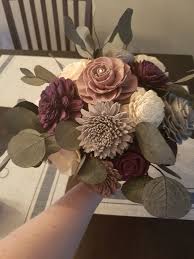 It looks like they got their piece of wood they were going to use, then drilled little holes for each flower. My Diy Sola Wood Flower Bouquet