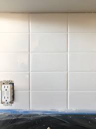 Installing a subway tile backsplash into your kitchen provides both an updated look (that will never go out of style) and a neutral one. Installing A Stacked Bond Subway Tile Backplash Door Sixteen