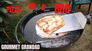 a weber bbq using a pizza stone