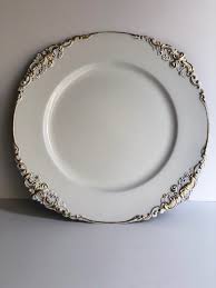 This person carries meals on plates to people in restaurants. White Under Plates Embossed Gold Edging Outlandish Events