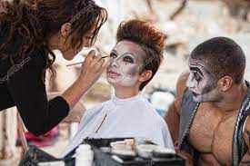 clowns getting makeup stock photo by